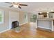 Open-concept living room with a fireplace and seamless access to the kitchen at 4502 Mill Creek Rd, Cedar Grove, NC 27231