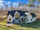 Aerial view of a modern home with a screened porch, patio, and spacious backyard at 472 Stonecrest Way, Pittsboro, NC 27312