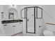 Contemporary bathroom featuring a walk-in shower with black fixtures, a white marble tile, and a sleek vanity at 472 Stonecrest Way, Pittsboro, NC 27312