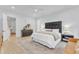 Bright bedroom with a black upholstered headboard, walk-in closet, and decorative area rug at 472 Stonecrest Way, Pittsboro, NC 27312