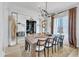 Spacious dining room showcasing a large table, decorative chandelier, and stylish décor at 472 Stonecrest Way, Pittsboro, NC 27312