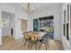 Bright dining room with modern light fixture and access to screened porch at 472 Stonecrest Way, Pittsboro, NC 27312