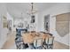 Open dining area with hardwood floors, modern light fixture, and access to the kitchen at 472 Stonecrest Way, Pittsboro, NC 27312