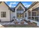 Chic firepit area in backyard with triangular window feature and covered patio at 472 Stonecrest Way, Pittsboro, NC 27312