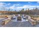 Beautiful stone firepit area surrounded by comfortable seating and a gravel base at 472 Stonecrest Way, Pittsboro, NC 27312