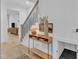 Inviting foyer featuring a stylish console table, hardwood floors, and a staircase at 472 Stonecrest Way, Pittsboro, NC 27312