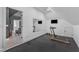 Home gym with treadmill, mirror, and television; accessible from bonus room at 472 Stonecrest Way, Pittsboro, NC 27312