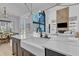 Bright, open kitchen featuring an island with a farmhouse sink, modern faucet, and large windows at 472 Stonecrest Way, Pittsboro, NC 27312