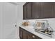 Modern kitchen beverage center with dark wood cabinets and marble countertop at 472 Stonecrest Way, Pittsboro, NC 27312