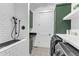 Functional laundry room with a dog washing station, washer, dryer, and tiled floor at 472 Stonecrest Way, Pittsboro, NC 27312