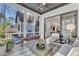 Screened porch with wood flooring, comfortable seating, and view of backyard at 472 Stonecrest Way, Pittsboro, NC 27312