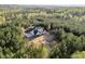 Aerial view of home nestled within a lush green forest, offering privacy and serenity at 494 Terry Rd, Hillsborough, NC 27278