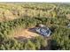Captivating aerial view of a beautiful home surrounded by dense greenery, creating a private and serene atmosphere at 494 Terry Rd, Hillsborough, NC 27278