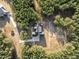 Bird's-eye view of a home with a large driveway surrounded by lush trees, offering a private and tranquil setting at 494 Terry Rd, Hillsborough, NC 27278