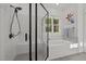 Bright bathroom showcases glass enclosed shower, soaking tub with tile surround, and stylish fixtures at 494 Terry Rd, Hillsborough, NC 27278