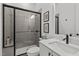 Modern bathroom features a black framed shower with gray tiling and a white vanity with quartz countertop at 494 Terry Rd, Hillsborough, NC 27278
