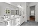 Bright bathroom features double vanity, large mirror, modern lighting, walk-in shower, and soaking tub in view at 494 Terry Rd, Hillsborough, NC 27278