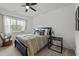 Cozy bedroom with a dark wood bed frame, light green bedding, and a window at 494 Terry Rd, Hillsborough, NC 27278