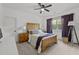 Bedroom with light hardwood furniture, a window with purple curtains, and gray and blue bedding at 494 Terry Rd, Hillsborough, NC 27278