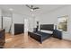 Spacious bedroom with hardwood floors, ceiling fan, recessed lighting, and modern dark wood furniture at 494 Terry Rd, Hillsborough, NC 27278