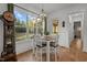 Bright and inviting dining area features large windows with scenic views and modern chandelier at 494 Terry Rd, Hillsborough, NC 27278