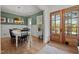 Inviting dining room featuring wainscoting, hardwood floors, and a large glass door at 494 Terry Rd, Hillsborough, NC 27278