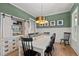 Stylish dining area with decorative storage cabinet, modern lighting, and ample seating at 494 Terry Rd, Hillsborough, NC 27278