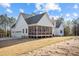 Rear exterior featuring a screened porch, two-car garage and spacious yard at 494 Terry Rd, Hillsborough, NC 27278