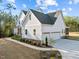 Beautiful two-story home with a three-car garage, manicured lawn, and a lovely sidewalk leading to the entrance at 494 Terry Rd, Hillsborough, NC 27278