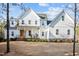 Beautiful white farmhouse with board and batten siding and a welcoming front porch at 494 Terry Rd, Hillsborough, NC 27278