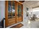 Inviting front porch with double glass doors, rocking chairs, and a 'Welcome' mat, creating a warm entrance at 494 Terry Rd, Hillsborough, NC 27278