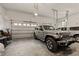 Spacious three car garage featuring epoxy flooring with Jeep and other vehicle, storage shelves, and plenty of room at 494 Terry Rd, Hillsborough, NC 27278