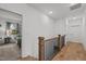 Bright hallway with hardwood floors and a view into a bedroom with natural light from the window at 494 Terry Rd, Hillsborough, NC 27278