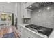 Gourmet kitchen features stainless steel appliances, quartz countertops, modern cabinets, and a gas cooktop at 494 Terry Rd, Hillsborough, NC 27278