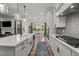 Gourmet kitchen features stainless steel appliances, quartz countertops, modern cabinets, and a large farmhouse sink at 494 Terry Rd, Hillsborough, NC 27278