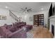 Well lit living area with open stairs and dark colored furniture set at 494 Terry Rd, Hillsborough, NC 27278