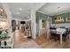 Open-concept living area with fireplace, wood floors, and seamless flow into the dining room at 494 Terry Rd, Hillsborough, NC 27278