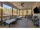 Relaxing screened-in porch with comfortable seating, string lights, and a peaceful view of the surrounding woods at 494 Terry Rd, Hillsborough, NC 27278