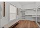 Spacious walk-in closet features custom shelving, bench, and large window for natural light at 494 Terry Rd, Hillsborough, NC 27278
