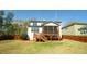 Exterior: backyard view of a two-story house showing a screened porch with stairs at 504 Prince Dr, Holly Springs, NC 27540
