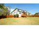 Exterior: backyard view of a two-story house showing a screened porch with stairs and a wood fence at 504 Prince Dr, Holly Springs, NC 27540