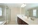 Bathroom with dual sink vanity, a large mirror, shower and soaking tub at 504 Prince Dr, Holly Springs, NC 27540