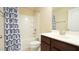 Bright bathroom with a shower and tub combination and a modern vanity at 504 Prince Dr, Holly Springs, NC 27540