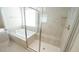 Bathroom features soaking tub and separate glass shower with light colored tile at 504 Prince Dr, Holly Springs, NC 27540