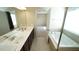 Bathroom with dual sink vanity, a large mirror, shower and soaking tub at 504 Prince Dr, Holly Springs, NC 27540