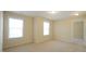 Bedroom with carpet, two large windows, and doorway at 504 Prince Dr, Holly Springs, NC 27540