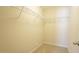 Walk-in closet with shelving and neutral carpet at 504 Prince Dr, Holly Springs, NC 27540