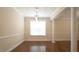 Dining room features decorative columns, a window, and a modern chandelier at 504 Prince Dr, Holly Springs, NC 27540