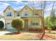 Inviting two-story home with a well-maintained lawn, an attached garage and a quaint front porch at 504 Prince Dr, Holly Springs, NC 27540