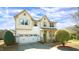 Charming two-story home with a two-car garage and well-manicured landscaping in a suburban neighborhood at 504 Prince Dr, Holly Springs, NC 27540